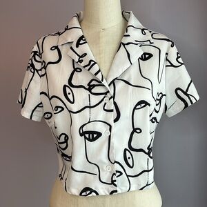SHEIN white and black short sleeve cropped button up blouse drawings of faces M